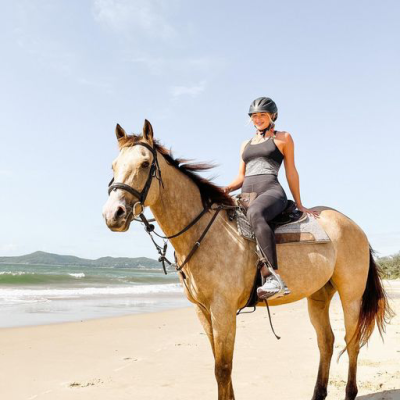 a person riding a horse on a beach
