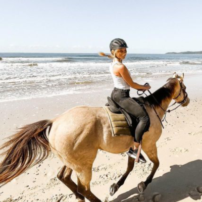 a person riding a horse on a beach