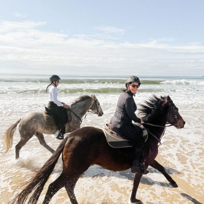 a man riding a horse on a beach