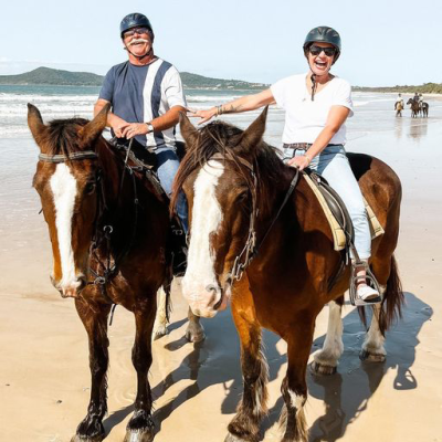 a man riding a horse on a beach