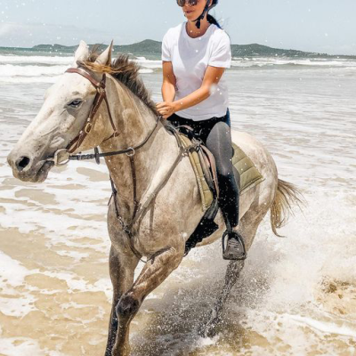 a man riding a horse in a body of water